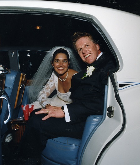 Busey and Warden in their car after the wedding, in their wedding dresses.